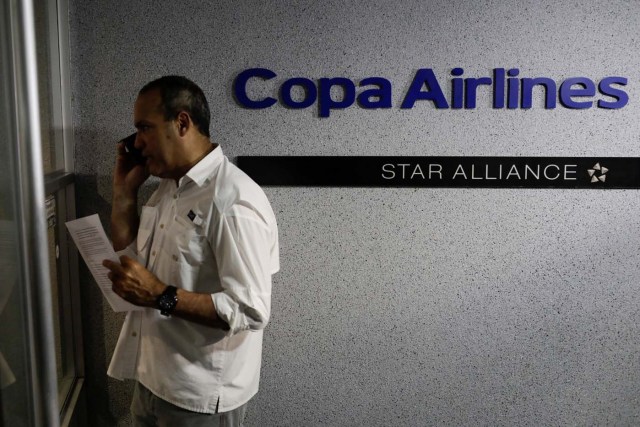 A man stands at the gates of Copa Airlines headquarters in Caracas, Venezuela April 6, 2018. REUTERS/Marco Bello