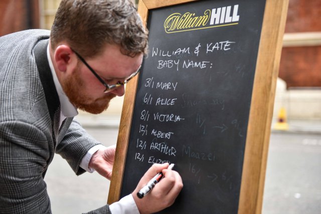 Joe Crilly, a spokesperson from the bookmaker William Hill, writes the names and betting odds for the third royal baby of Britain's Prince William and Catherine, Duchess of Cambridge, on a board outside the Lindo Wing St Mary's Hospital in west London, Britain, April 13, 2018. REUTERS/Peter Summers
