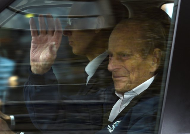 Britain's Prince Philip waves as he is driven away from King Edward VII's Hospital where he recently underwent hip replacement surgery, in central London, April 13, 2018. REUTERS/Peter Summers