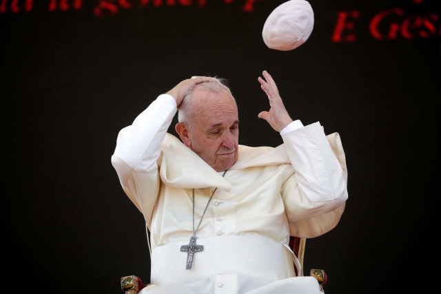 A gust of wind blows Pope Francis's skull cap off during his pastoral visit in Alessano, southern Italy, April 20, 2018. REUTERS/Max Rossi