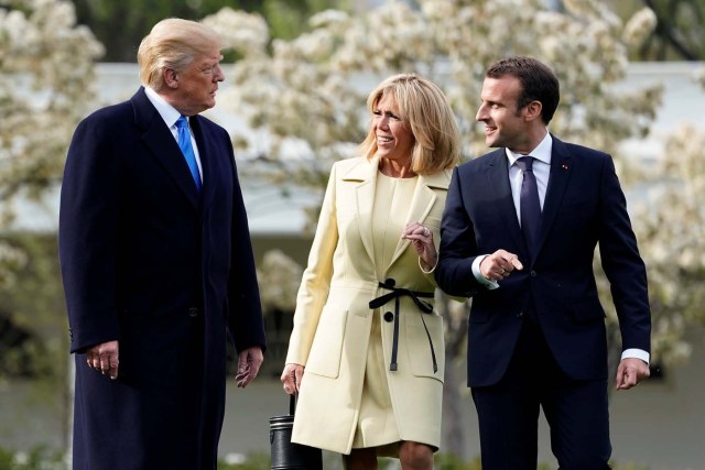 U.S. President Donald Trump speaks to French President Emmanuel Macron and Brigitte Macron on the South Lawn of the White House in Washington, U.S., April 23, 2018. REUTERS/Joshua Roberts