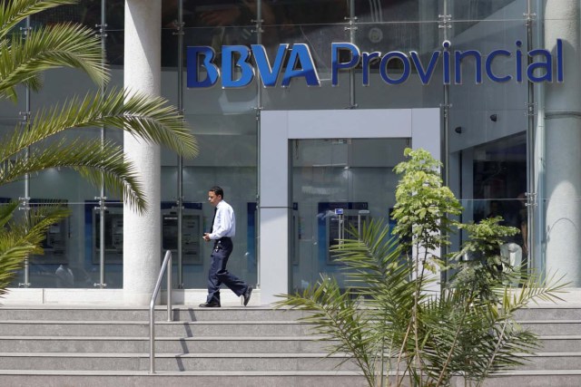 A man walks outside a branch of BBVA Provincial bank in Caracas, Venezuela April 6, 2018. Picture taken April 6, 2018. REUTERS/Marco Bello