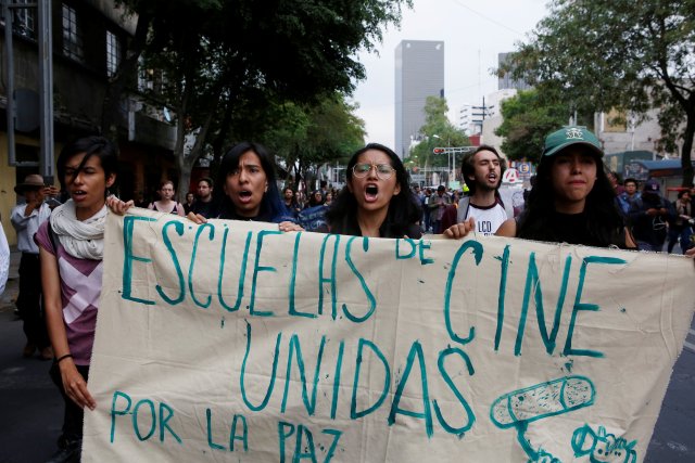 Demonstrators hold a banner during a protest to demand justice for the three film students kidnapped and killed by gunmen after being confused with members of a rival gang in the state of Jalisco, in Mexico City, Mexico April 24, 2018. REUTERS/Ginnette Riquelme