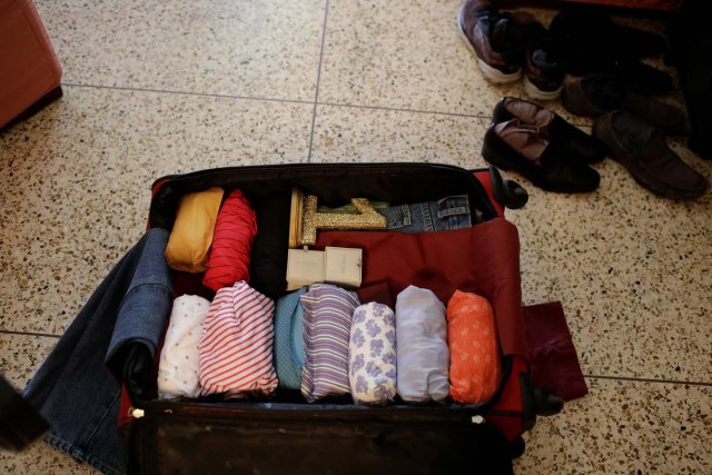 Carlos Alzaibar's clothes are seen in his suitcase, at his home in Caracas, Venezuela March 14, 2018. Picture taken March 14, 2018. REUTERS/Marco Bello
