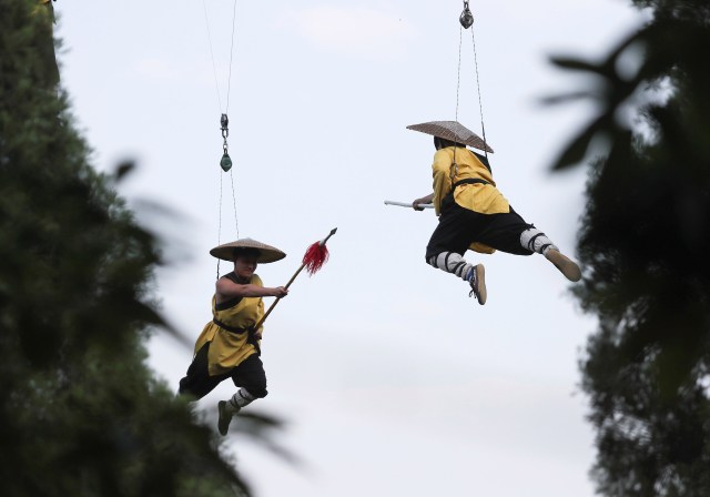 Shaolin martial arts students perform Kung Fu suspended on wires in a rehearsal for a live-action night show in Zhengzhou, Henan province, China April 28, 2018. Picture taken April 28, 2018. REUTERS/Stringer ATTENTION EDITORS - THIS IMAGE WAS PROVIDED BY A THIRD PARTY. CHINA OUT. NO COMMERCIAL OR EDITORIAL SALES IN CHINA.