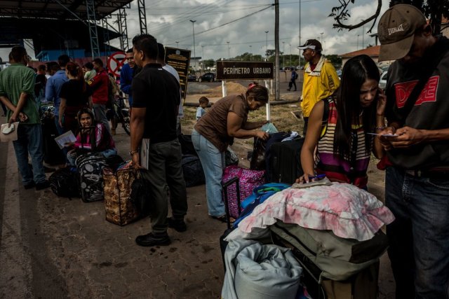 Un grupo de venezolanos hace fila para registrarse ante las autoridades migratorias brasileñas y luego cruzar la frontera hacia ese país. Credit Meridith Kohut para The New York Times