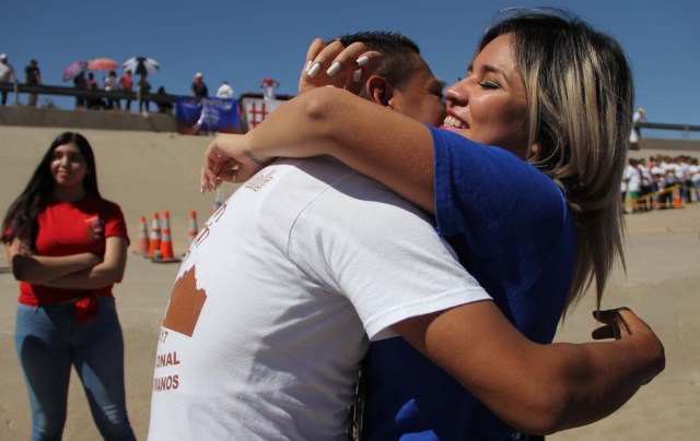 Mexican families living in US and Mexico embrace at the border line in the bank of Rio Grande to take part in the event called "Abrazos No Muros" (Hugs, not walls) promoted by the Border Network of Human Rights organization in the border line between El Paso, Texas, United States and Ciudad Juarez, Chihuahua state, Mexico on May 12, 2018. / AFP PHOTO / HERIKA MARTINEZ