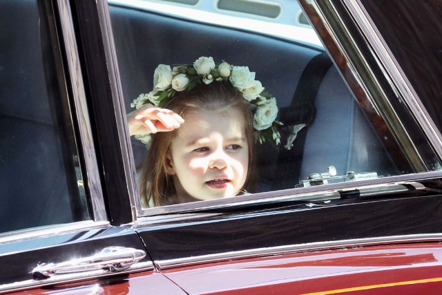 Prince Harry's niece and bridesmaid Princess Charlotte arrives for the wedding ceremony of Britain's Prince Harry, Duke of Sussex and US actress Meghan Markle at St George's Chapel, Windsor Castle, in Windsor, on May 19, 2018. / AFP PHOTO / POOL / Chris Jackson