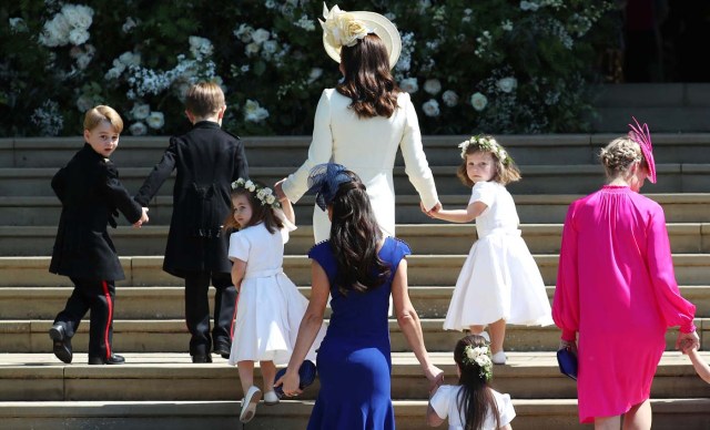 Britain's Catherine, Duchess of Cambridge (C) walks up the west steps with Prince George (L) and Princess Charlotte (3L) and bridesmaids for the wedding ceremony of Britain's Prince Harry, Duke of Sussex and US actress Meghan Markle at St George's Chapel, Windsor Castle, in Windsor, on May 19, 2018. / AFP PHOTO / POOL / Jane Barlow