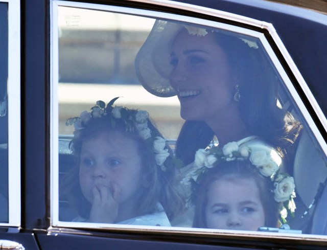 Britain's Catherine, Duchess of Cambridge arrives with Prince Harry's niece and bridesmaid Princess Charlotte (R) for the wedding ceremony of Britain's Prince Harry, Duke of Sussex and US actress Meghan Markle at St George's Chapel, Windsor Castle, in Windsor, on May 19, 2018. / AFP PHOTO / POOL / Ben Birchall