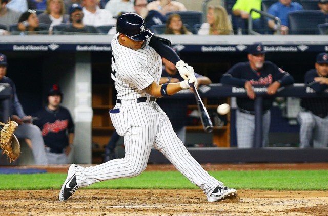May 4, 2018; Bronx, NY, USA; New York Yankees second baseman Gleyber Torres (25) hits his first MLB home run, a three run homer against the Cleveland Indians during the fourth inning at Yankee Stadium. Mandatory Credit: Andy Marlin-USA TODAY Sports