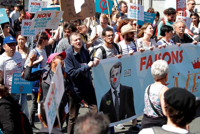 Demonstrators march during an anti-Macron "festive" protest called by far-left opposition "France Insoumise" (France Unbowed) political party two days ahead of the first anniversary of his election as President, in Paris, France, May 5, 2018. REUTERS/Charles Platiau