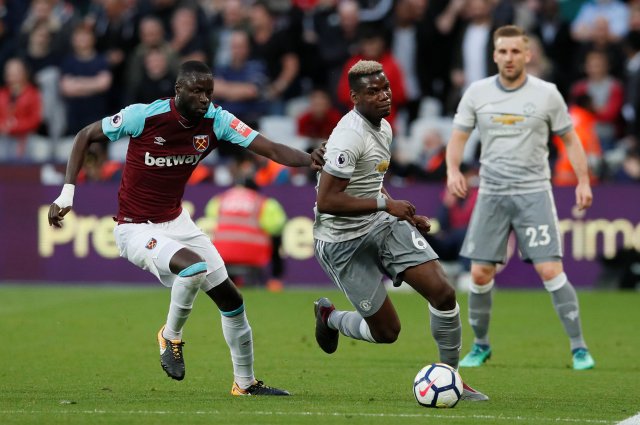 Soccer Football - Premier League - West Ham United v Manchester United - London Stadium, London, Britain - May 10, 2018   Manchester United's Paul Pogba in action with West Ham United's Cheikhou Kouyate    REUTERS/David Klein    EDITORIAL USE ONLY. No use with unauthorized audio, video, data, fixture lists, club/league logos or "live" services. Online in-match use limited to 75 images, no video emulation. No use in betting, games or single club/league/player publications.  Please contact your account representative for further details.