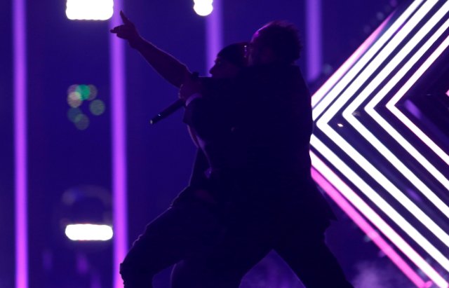 Security subdues a person who invaded the stage as United Kingdom's SuRie performed "Storm" during the Grand Final of Eurovision Song Contest 2018 at the Altice Arena hall in Lisbon, Portugal, May 12, 2018.  REUTERS/Pedro Nunes