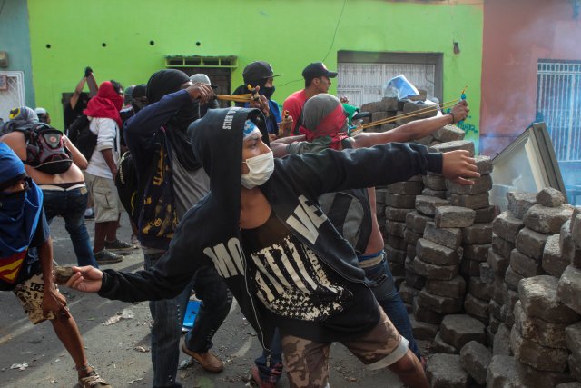 Demonstrators throw rocks towards riot police during a protest against Nicaraguan President Daniel Ortega's government in Monimbo, Nicaragua May 12, 2018. REUTERS/Oswaldo Rivas