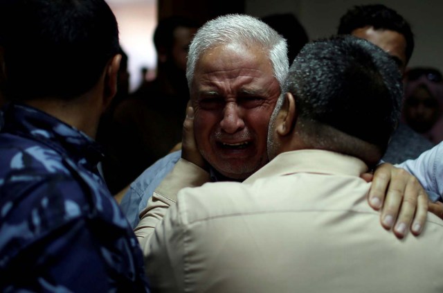 A relative of Palestinian Ahmed al-Rantisi, who was killed during a protest at the Israel-Gaza border, is consoled at a hospital in the northern Gaza Strip May 14, 2018. REUTERS/Mohammed Salem TPX IMAGES OF THE DAY