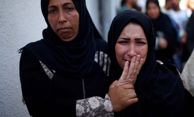 The mother of 8-month-old Palestinian infant Laila al-Ghandour, who died after inhaling tear gas during a protest against U.S. embassy move to Jerusalem at the Israel-Gaza border, mourns during her funeral in Gaza City May 15, 2018. REUTERS/Mohammed Salem