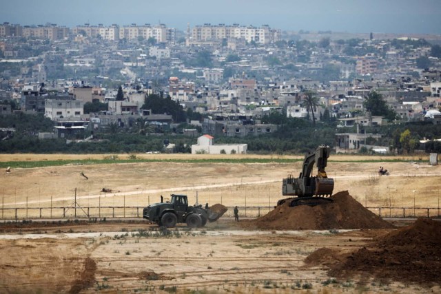 Israeli bulldozers work on a position on the Israeli side of the border fence between Israel and the Gaza Strip May 15, 2018. REUTERS/Amir Cohen