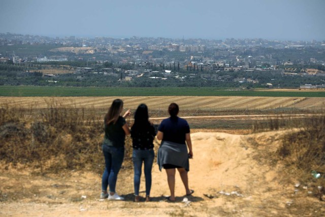 Women look at the direction of the Gaza Strip, on the Israeli side of the border between Israel and the Gaza Strip May 15, 2018. REUTERS/Amir Cohen