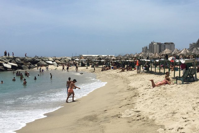 People enjoy a day on the beach in La Guaira, Venezuela May 17, 2018. Picture taken on May 17, 2018. REUTERS/Luc Cohen