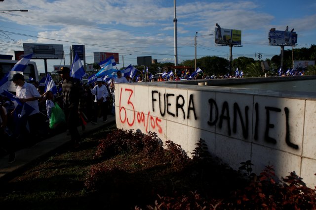 Protesters take part in a demonstration against President Daniel Ortega's government in Managua, Nicaragua May 18, 2018. The graffiti reads "Daniel out". REUTERS/Oswaldo Rivas