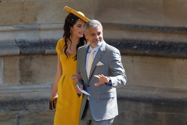 US actor George Clooney (R) and his wife British lawyer Amal Clooney (L) arrive for the wedding ceremony of Britain's Prince Harry, Duke of Sussex and US actress Meghan Markle at St George's Chapel, Windsor Castle, in Windsor, on May 19, 2018. Odd ANDERSEN/Pool via REUTERS