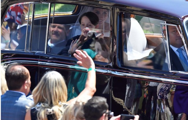 Meghan Markle is driven to St George's Chapel in Windsor Castle along with some of her page boys during her wedding to Britain’s Prince Harry, in Windsor, Britain, May 19, 2018. REUTERS/Toby Melville/Pool