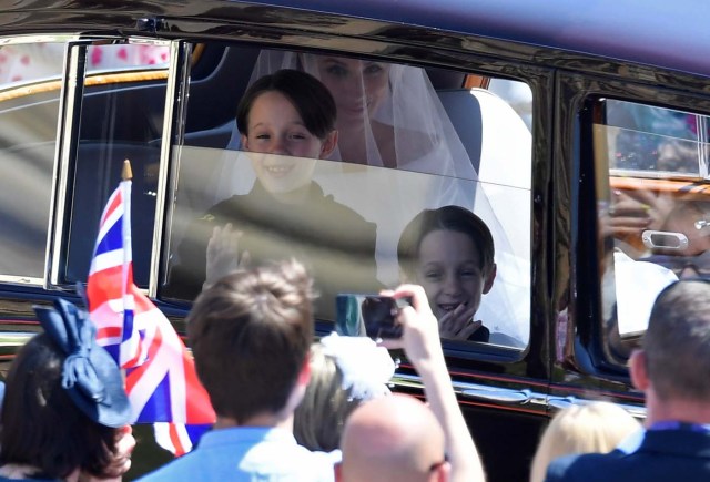 Meghan Markle is driven to St George's Chapel in Windsor Castle along with some of her page boys during her wedding to Britain’s Prince Harry, in Windsor, Britain, May 19, 2018. REUTERS/Toby Melville/Pool