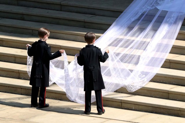 Pageboys hold the train of the dress of Meghan Markle as she arrives at St George's Chapel at Windsor Castle for her wedding to Prince Harry in Windsor, Britain, May 19, 2018. Andrew Matthews/Pool via REUTERS