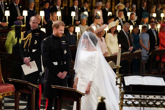 Prince Harry looks at his bride, Meghan Markle, as she arrives accompanied by the Prince of Wales in St George's Chapel at Windsor Castle for their wedding in Windsor, Britain, May 19, 2018. Jonathan Brady/Pool via REUTERS