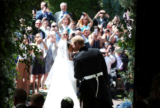 Prince Harry and Meghan Markle kiss on the steps of St George's Chapel in Windsor Castle after their wedding in Windsor, Britain, May 19, 2018. Danny Lawson/Pool via REUTERS