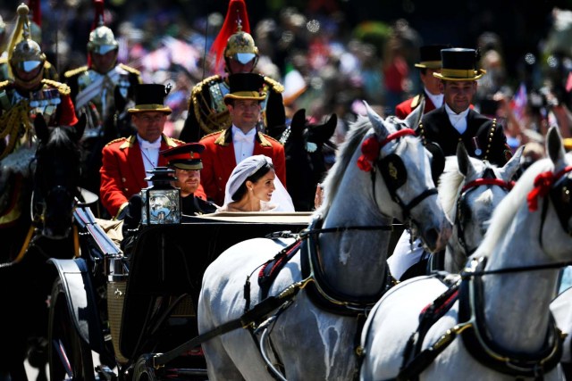Prince Harry, Duke of Sussex and the Duchess of Sussex in the Ascot Landau carriage during the procession on The Long Walk after getting married St George's Chapel, Windsor Castle on May 19, 2018 in Windsor, England. Jeff J Mitchell/Pool via REUTERS
