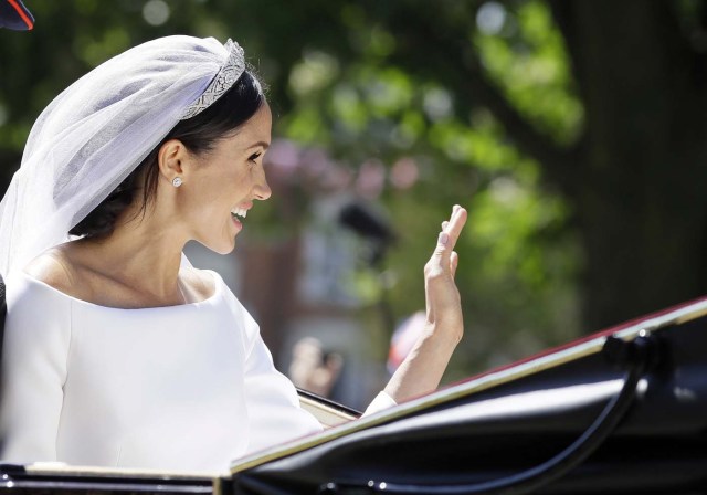 Meghan Markle waves from a carriage after the wedding ceremony of Prince Harry and Meghan Markle at St. George's Chapel in Windsor Castle in Windsor, near London, England, Saturday, May 19, 2018. Kirsty Wigglesworth/Pool via REUTERS