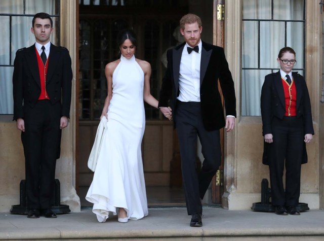 The newly married Duke and Duchess of Sussex, Meghan Markle and Prince Harry, leaving Windsor Castle after their wedding to attend an evening reception at Frogmore House, hosted by the Prince of Windsor, Britain, May 19, 2018. Steve Parsons/Pool via REUTERS