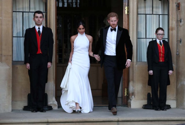 The newly married Duke and Duchess of Sussex, Meghan Markle and Prince Harry, leaving Windsor Castle after their wedding to attend an evening reception at Frogmore House, hosted by the Prince of Wales Windsor, Britain, May 19, 2018. Steve Parsons/Pool via REUTERS