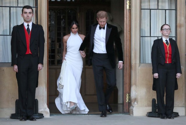 The newly married Duke and Duchess of Sussex, Meghan Markle and Prince Harry, leaving Windsor Castle after their wedding to attend an evening reception at Frogmore House, hosted by the Prince of Wales Windsor, Britain, May 19, 2018. Steve Parsons/Pool via REUTERS