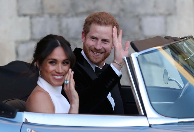 The newly married Duke and Duchess of Sussex, Meghan Markle and Prince Harry, leaving Windsor Castle after their wedding to attend an evening reception at Frogmore House, hosted by the Prince of Wales Windsor, Britain, May 19, 2018.. Steve Parsons/Pool via REUTERS