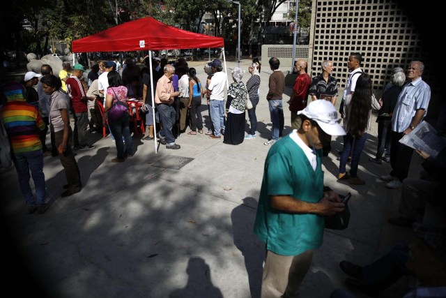 Venezuelan citizens wait to check in at a "Red Point," an area set up by President Nicolas Maduro's party, to verify that they cast their votes during the presidential election in Caracas, Venezuela, May 20, 2018. REUTERS/Carlos Garcia Rawlins
