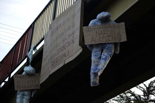 Stuffed mannequins representing Venezuelan government officials hang from a bridge during the presidential election in San Cristobal, Venezuela, May 20, 2018. REUTERS/Carlos Eduardo Ramirez