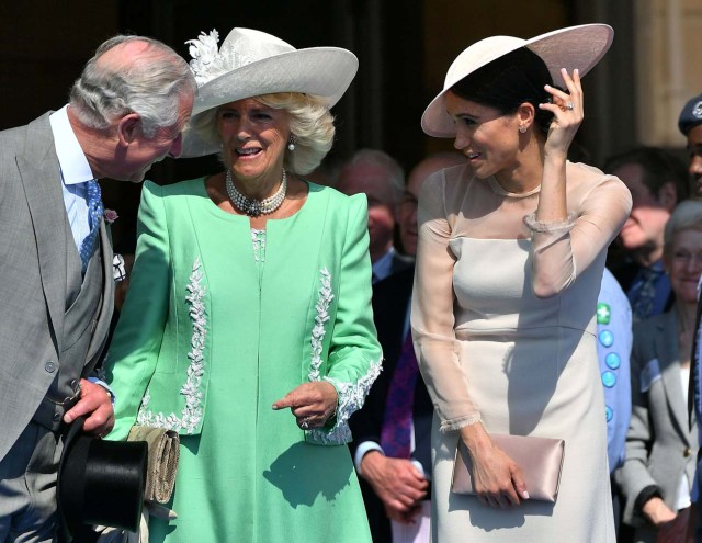 Meghan, Duchess of Sussex attends a garden party at Buckingham Palace, with Camilla the Duchess of Cornwall and Prince Charles, in London, Britain May 22, 2018. Dominic Lipinski/Pool via Reuters
