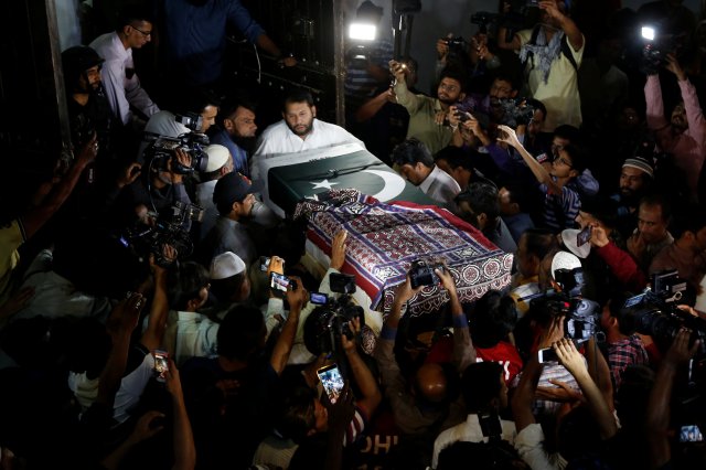 Relatives carry the casket, wrapped in a national flag and shawl, locally known as Ajrak, containing the body of Sabika Aziz Sheikh, a Pakistani exchange student, who was killed with others when a gunman attacked Santa Fe High School in Santa Fe, Texas, U.S., outside her residence in Karachi, Pakistan May 23, 2018. REUTERS/Akhtar Soomro