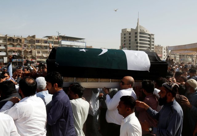 Relatives and neighbours carry the coffin, wrapped in national flag, containing the body of Sabika Aziz Sheikh, a Pakistani exchange student, who was killed with others when a gunman attacked Santa Fe High School in Santa Fe, Texas, U.S., during her funeral in Karachi, Pakistan May 23, 2018. REUTERS/Akhtar Soomro