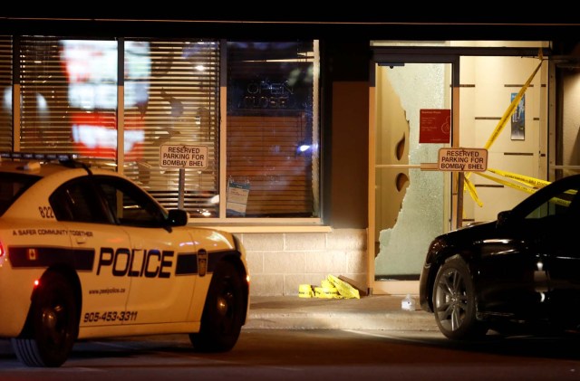 A police car is parked in front of shattered glass at the Bombay Bhel restaurant, where two unidentified men set off a bomb late Thursday night, wounding more than a dozen people, in Mississauga, Ontario, Canada May 25, 2018. REUTERS/Mark Blinch