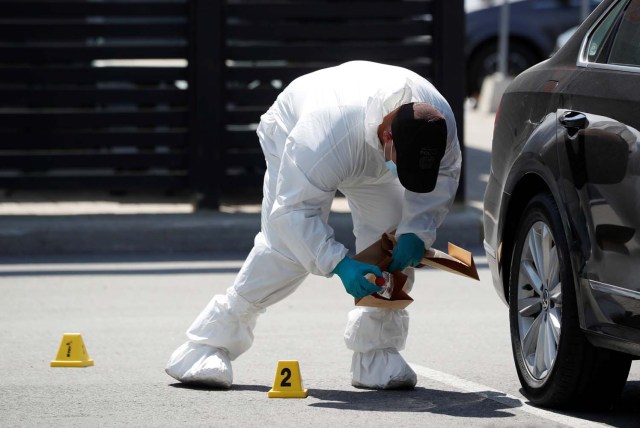 A police forensic investigator collects evidence at Bombay Bhel restaurant, where two unidentified men set off a bomb late Thursday night, wounding fifteen people, in Mississauga, Ontario, Canada May 25, 2018. REUTERS/Mark Blinch