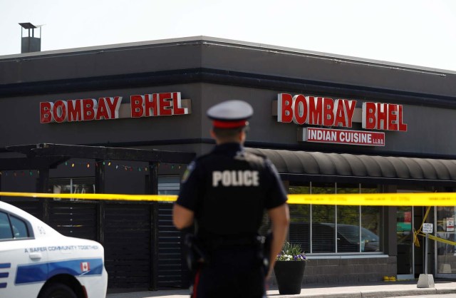 A police officer stands in front of Bombay Bhel restaurant, where two unidentified men set off a bomb late Thursday night, wounding fifteen people, in Mississauga, Ontario, Canada May 25, 2018. REUTERS/Mark Blinch