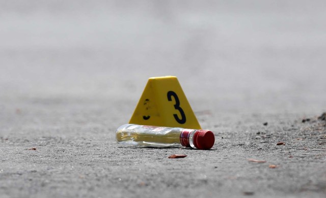 An evidence marker sits on the pavement at Bombay Bhel restaurant, where two unidentified men set off a bomb late Thursday night, wounding fifteen people, in Mississauga, Ontario, Canada May 25, 2018. REUTERS/Mark Blinch