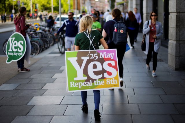 A woman carries a placard as Ireland holds a referendum on liberalising abortion laws, in Dublin, Ireland, May 25, 2018. REUTERS/Max Rossi