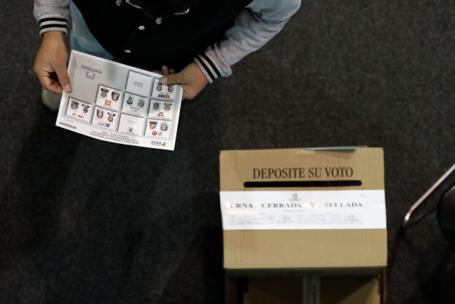 Un hombre se prepara para depositar su voto en un casillero en un colegio electoral instalado en un centro de convenciones mientras los colombianos votan por un nuevo presidente en Bogotá, Colombia, el 27 de mayo de 2018. REUTERS / Carlos Garcia Rawlins