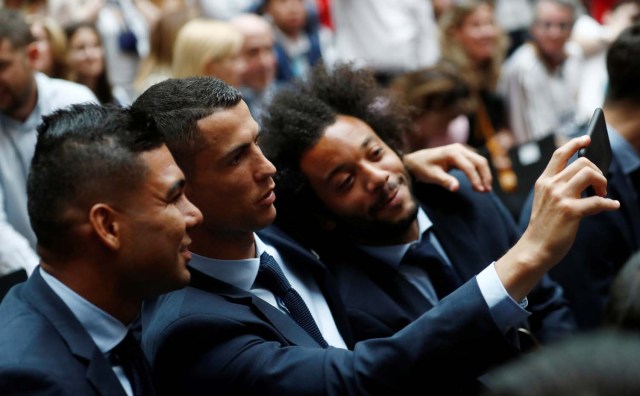 Soccer Football - Real Madrid celebrate winning the Champions League Final - Madrid, Spain - May 27, 2018   Real Madrid's Cristiano Ronaldo takes a selfie with Casemiro and Marcelo    REUTERS/Javier Barbancho