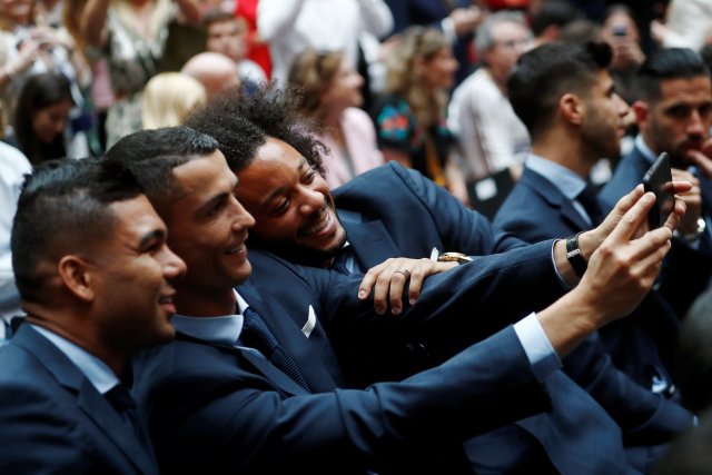 Soccer Football - Real Madrid celebrate winning the Champions League Final - Madrid, Spain - May 27, 2018   Real Madrid's Cristiano Ronaldo takes a selfie with Casemiro and Marcelo    REUTERS/Javier Barbancho